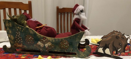 A model of Death as the Hogfather in his sleigh, pulled by four pigs