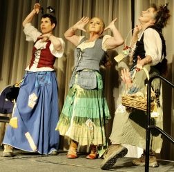 Three Maskerade entrants dressed as Seamstresses dancing