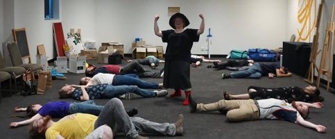 Nanny Ogg stands triumphant over a large number of people lying on the floor, like she's just won a fight. (Nullus Anxietas 7, 2019)