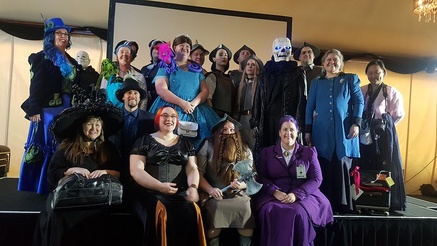 Discworld fans in costume pose for a photo, very happy with themselves for having survived.